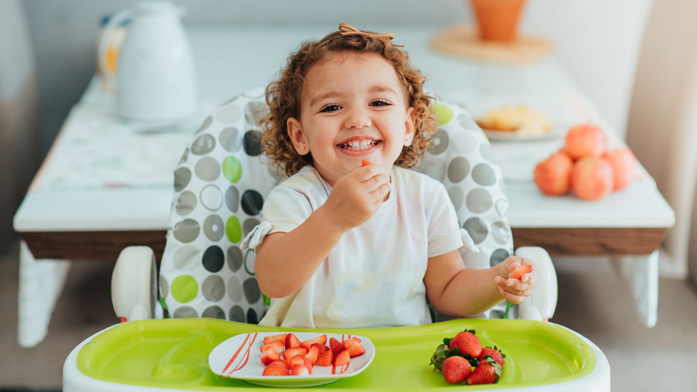 kid eating strawberries in a high chair - picky eating